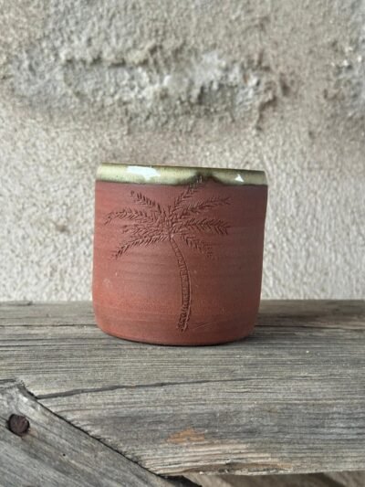 Beker uit rode klei met een ingekerfde palmboom en een beige geglazuurde rand